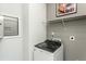 This laundry room has a gray top-load washing machine and a window for natural light at 2308 Beeblossom Pl, Fuquay Varina, NC 27526