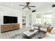 Modern living room with a TV and a glimpse into the bedroom and an outdoor patio at 2308 Beeblossom Pl, Fuquay Varina, NC 27526