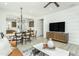 Open-concept living space with a dining area, modern decor, and a television, perfect for relaxation and entertainment at 2308 Beeblossom Pl, Fuquay Varina, NC 27526