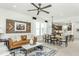 Stylish living room with a ceiling fan, dining area, and a glimpse into the kitchen, creating an inviting atmosphere at 2308 Beeblossom Pl, Fuquay Varina, NC 27526