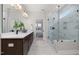 Modern bathroom featuring a double vanity, quartz countertop, and glass-enclosed shower with marble-like tile at 2317 Forsythia Trl, Fuquay Varina, NC 27526