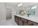 Modern bathroom featuring a double vanity, quartz countertop, and glass-enclosed shower with marble-like tile at 2317 Forsythia Trl, Fuquay Varina, NC 27526