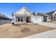 Attractive home exterior featuring a well-maintained lawn, neat landscaping, and a spacious driveway at 2317 Forsythia Trl, Fuquay Varina, NC 27526