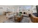 Inviting living room with a large window, comfortable seating, a stylish rug, and elegant decor at 2317 Forsythia Trl, Fuquay Varina, NC 27526
