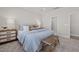 Relaxing main bedroom with a comfortable bed, stylish nightstands, and a cozy bench at 2317 Forsythia Trl, Fuquay Varina, NC 27526