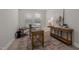 Stylish office space with a large window, wooden desk, and an elegant area rug that enhances the room's charm at 2317 Forsythia Trl, Fuquay Varina, NC 27526