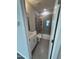 Modern bathroom with tiled walk-in shower, grey tile floors, and white vanity at 2391 Englemann Dr Dr # 124, Apex, NC 27502