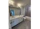 Modern bathroom with double sink vanity, quartz countertop, tiled floor, and tiled shower over tub at 2391 Englemann Dr Dr # 124, Apex, NC 27502