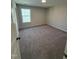 Neutral bedroom featuring plush carpet, one window providing natural light, and a walk in closet at 2391 Englemann Dr Dr # 124, Apex, NC 27502