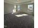 Spacious bedroom featuring plush carpeting, a tray ceiling, and abundant natural light at 2391 Englemann Dr Dr # 124, Apex, NC 27502