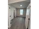 Cozy bedroom featuring new grey wood-look flooring, fresh paint, and ample natural light at 2391 Englemann Dr Dr # 124, Apex, NC 27502
