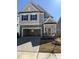 Charming two-story home featuring stone accents, a two-car garage, and a welcoming front porch at 2391 Englemann Dr Dr # 124, Apex, NC 27502
