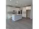 Bright kitchen featuring a center island, stainless steel appliances, and white cabinetry at 2391 Englemann Dr Dr # 124, Apex, NC 27502