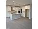 Modern kitchen with white cabinets, island, and stainless steel appliances at 2391 Englemann Dr Dr # 124, Apex, NC 27502