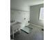 Functional laundry room featuring a utility sink, tile flooring, and ample storage space at 2391 Englemann Dr Dr # 124, Apex, NC 27502