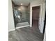 Modern bathroom with a glass-enclosed shower and tiled surround, plus an adjacent walk-in closet at 2391 Englemann Dr Dr # 124, Apex, NC 27502