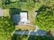 Aerial view of a home with a driveway, patio, and mature trees surrounding the property offering privacy at 320 W Orange St, Hillsborough, NC 27278