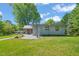 Exterior view of the house with backyard seating and beautiful landscaping at 320 W Orange St, Hillsborough, NC 27278