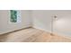 Bright, minimalist bedroom featuring hardwood floors, natural light, and a floor lamp at 320 W Orange St, Hillsborough, NC 27278