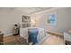 Well-lit bedroom with a comfortable bed and blue throw at 320 W Orange St, Hillsborough, NC 27278