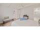 Spacious bedroom with a bench, ceiling fan, hardwood floors, and ample natural light at 320 W Orange St, Hillsborough, NC 27278