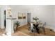 Dining room features a modern table with chairs, artwork, and hardwood flooring at 320 W Orange St, Hillsborough, NC 27278