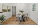 Dining room features a modern table, hardwood flooring, and natural light from a window at 320 W Orange St, Hillsborough, NC 27278