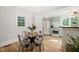 Dining room features a modern table next to a kitchen with stainless steel appliances at 320 W Orange St, Hillsborough, NC 27278