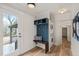 Entryway with built-in hall tree with seating and stacked laundry machines at 320 W Orange St, Hillsborough, NC 27278