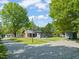 Exterior view of the house with a long driveway and a backyard shed at 320 W Orange St, Hillsborough, NC 27278