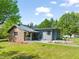 The exterior view shows the home's architectural details, landscaping, and outdoor living spaces at 320 W Orange St, Hillsborough, NC 27278