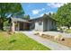 Beautiful home featuring brick and siding, lovely landscaping, and a charming patio with seating area at 320 W Orange St, Hillsborough, NC 27278