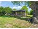 Landscaped front yard with brick home and tree swing creates a peaceful and inviting outdoor space at 320 W Orange St, Hillsborough, NC 27278