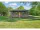 Charming brick home featuring a covered front porch, landscaped front yard, and beautiful curb appeal at 320 W Orange St, Hillsborough, NC 27278