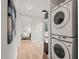 Hallway with stacked laundry machines and view to a seating area at 320 W Orange St, Hillsborough, NC 27278