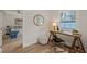 Bright home office space with a wooden desk, decorative mirror, and hardwood flooring at 320 W Orange St, Hillsborough, NC 27278