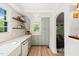 Well-lit kitchen featuring green cabinets, a farmhouse sink, and stylish decor providing a serene cooking environment at 320 W Orange St, Hillsborough, NC 27278