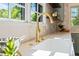 Bright kitchen showcases a gooseneck faucet and white countertops with view to the yard at 320 W Orange St, Hillsborough, NC 27278
