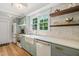 Sunlit kitchen features shaker cabinets, a farmhouse sink, and stainless steel appliances at 320 W Orange St, Hillsborough, NC 27278