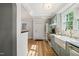 Spacious kitchen showcases a farmhouse sink, stainless steel appliances, and an entry door at 320 W Orange St, Hillsborough, NC 27278
