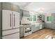 Elegant kitchen with modern appliances, custom cabinets, and ample counter space for culinary enthusiasts at 320 W Orange St, Hillsborough, NC 27278