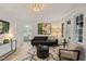 Stylish living room with hardwood floors, modern decor, and an open view to the kitchen area at 320 W Orange St, Hillsborough, NC 27278