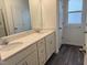 Bright bathroom features a double vanity with stone countertop and modern fixtures at 346 Tormore, Homesite 125, Sanford, NC 27330