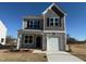 Charming two-story home with a stone-accented garage and covered front porch at 346 Tormore, Homesite 125, Sanford, NC 27330