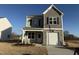 Charming two-story home with a stone-accented garage and covered front porch at 346 Tormore, Homesite 125, Sanford, NC 27330