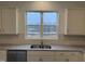 Bright kitchen featuring granite countertops, stainless steel appliances, and white cabinets at 346 Tormore, Homesite 125, Sanford, NC 27330