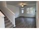 Bright, open-concept living area with wood floors, staircase, and natural light at 346 Tormore, Homesite 125, Sanford, NC 27330