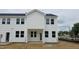 New townhouse with white vinyl siding and black window frames at 3936 Well Fleet Drive, Fuquay Varina, NC 27526