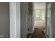 Inviting hallway with white doors leads to a sunlit living area at 3936 Well Fleet Drive, Fuquay Varina, NC 27526