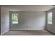 Spacious living room with two large windows providing plenty of natural light at 3936 Well Fleet Drive, Fuquay Varina, NC 27526